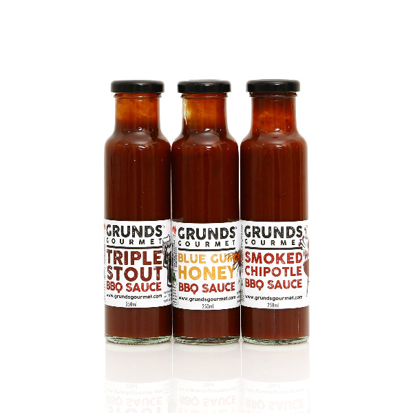 Three bottles of Grund's Gourmet BBQ Sauce on a white background