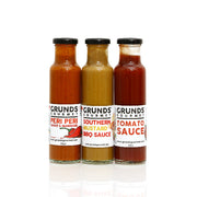 Three bottles of Grunds Gourmet sauces on a white background