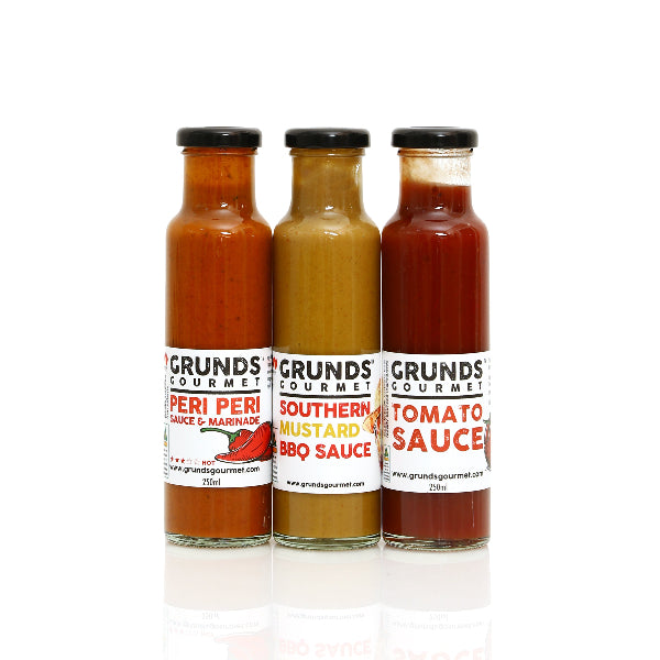 Three bottles of Grunds Gourmet sauces on a white background
