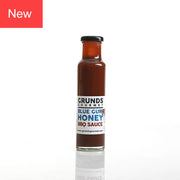 Bottle of Grunds Gourmet Blue Gum Honey BBQ Sauce on a white background