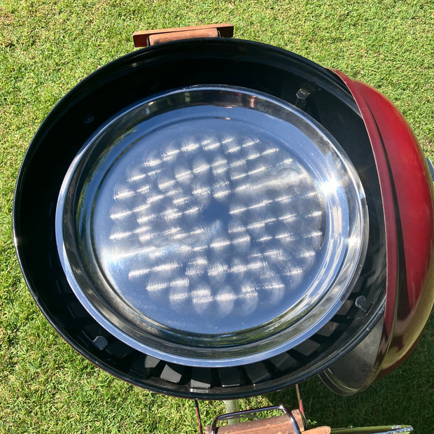 Close-up of a barbecue grill with a lid on a grassy background