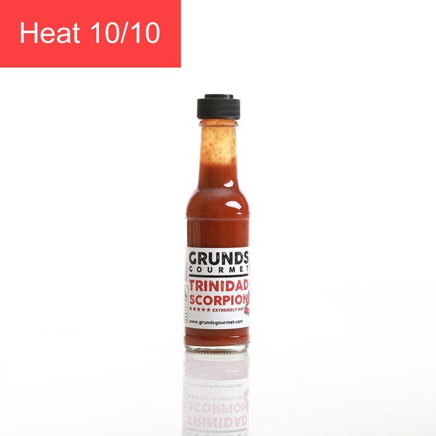 Bottle of Grundy's Trinidad Scorpion hot sauce with a heat rating on a white background