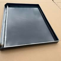 Black metal tray on a cardboard box