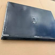 Black laptop on a cardboard surface